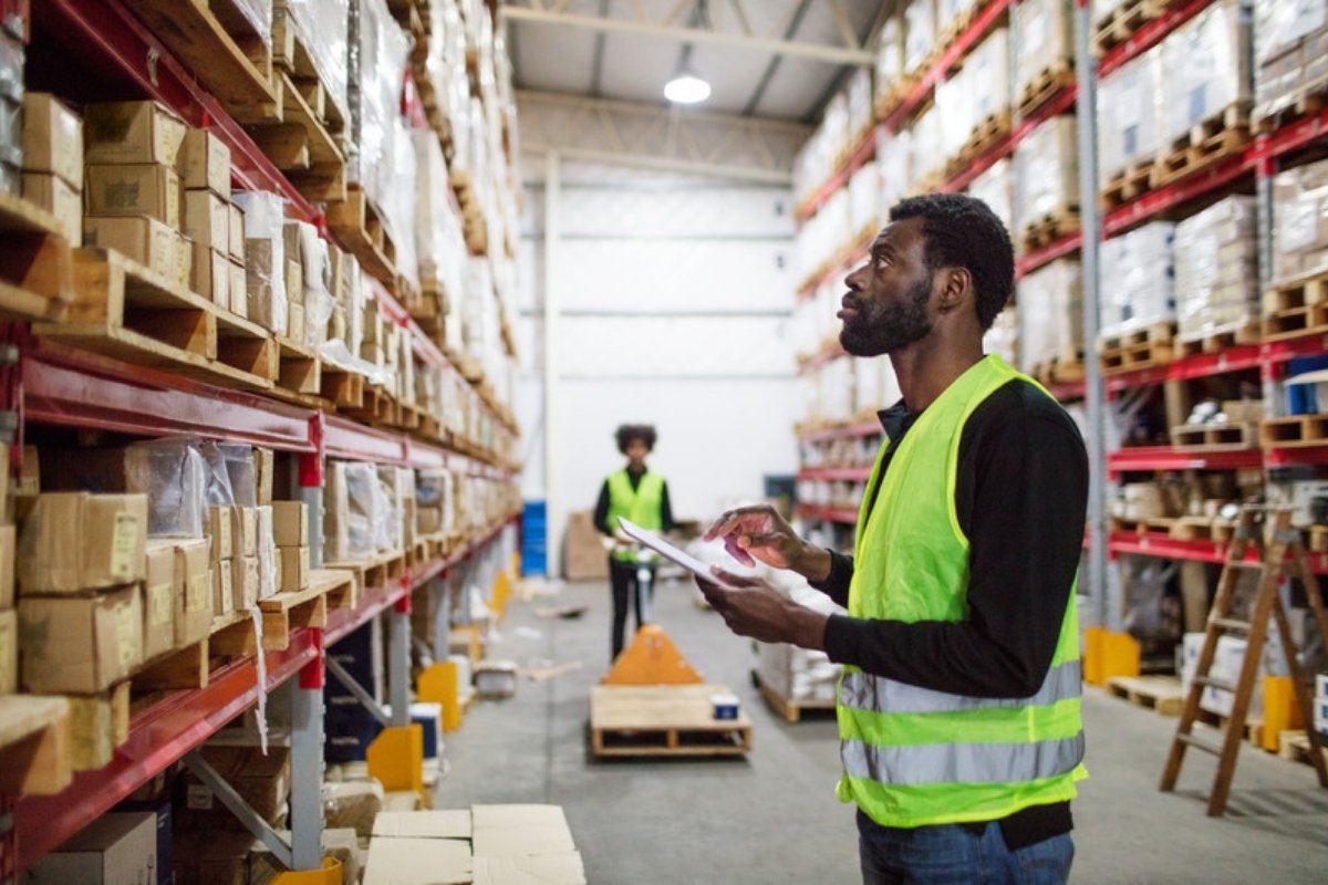Warehouse worker checking goods with a tablet A food industry ERP has added an AI agent that checks supplier invoices and waits for approval