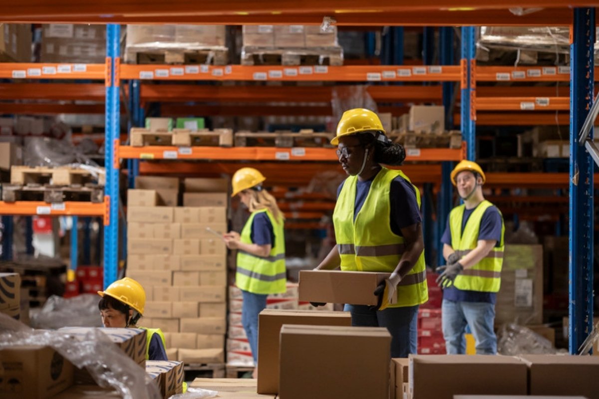 Workers handling boxes in a warehouse AI tools have started reading the food orders that still arrive outside e-commerce