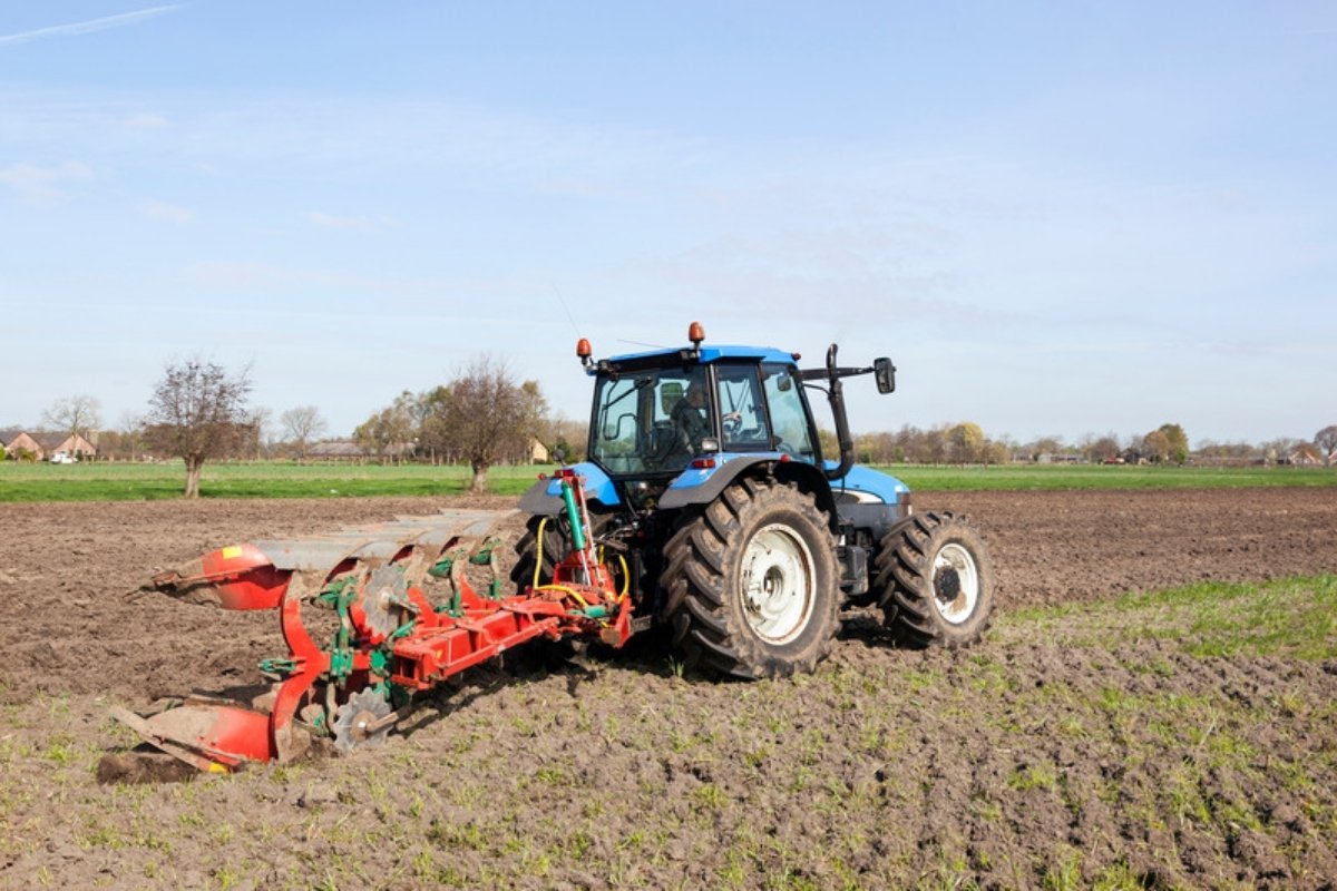 Tractor with a reversible mouldboard plough in an arable field