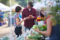 Shoppers at an open-air produce market Greeks doubt the CAP on food prices more than any other Europeans